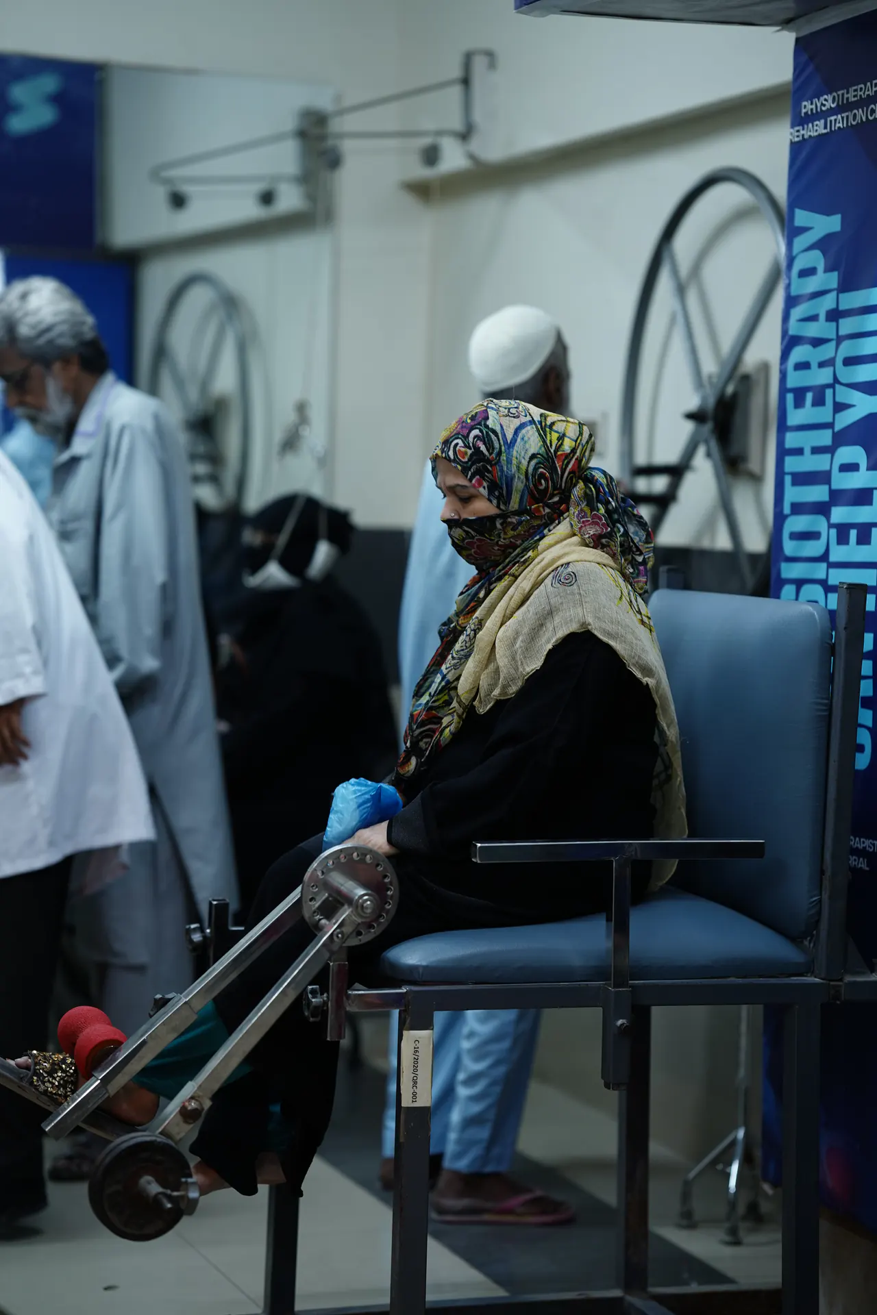 A patient seated on physiotherapy equipment at a ZMT rehabilitation centre