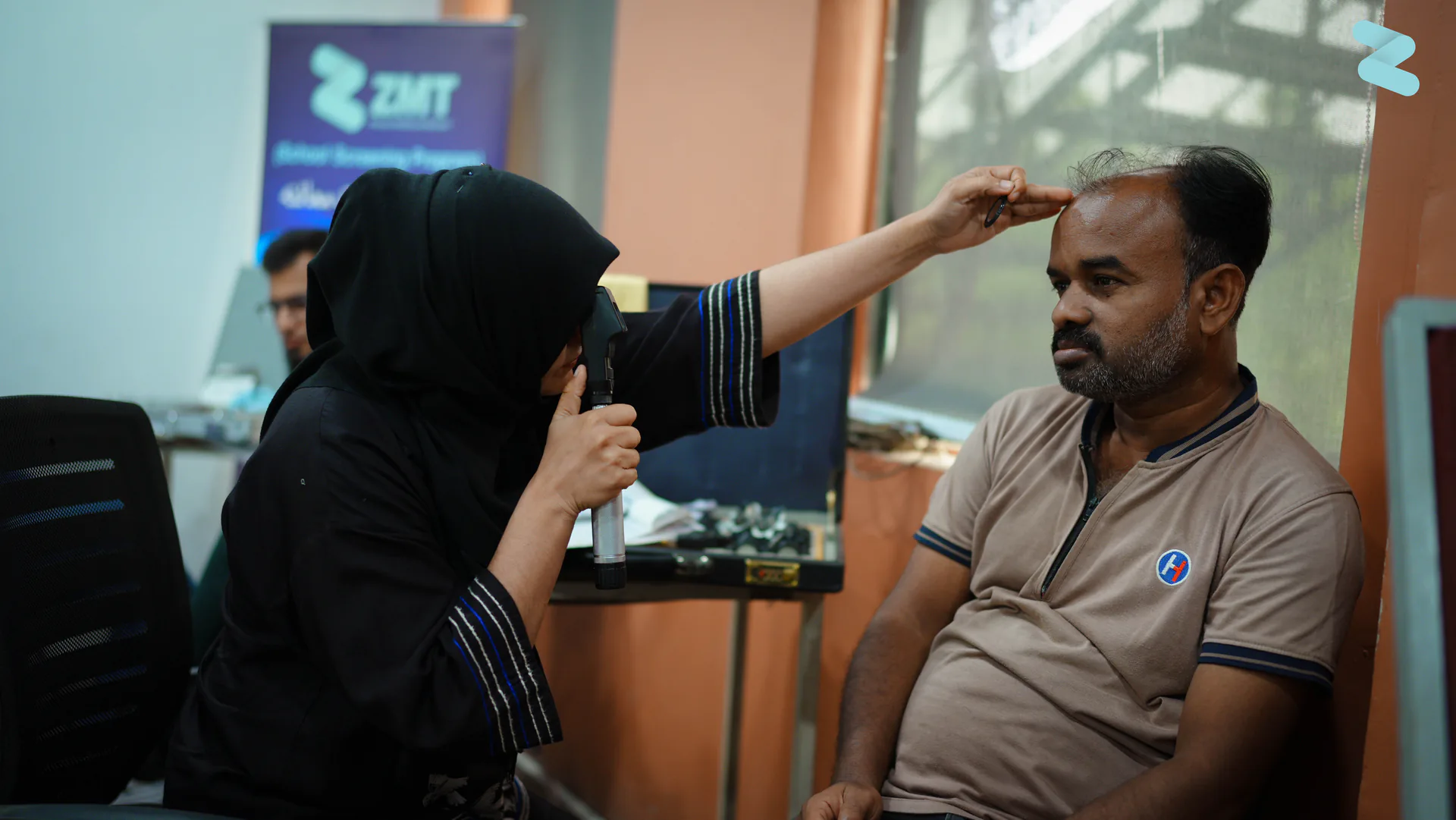 A ZMT optometrist examining a patient's eyes