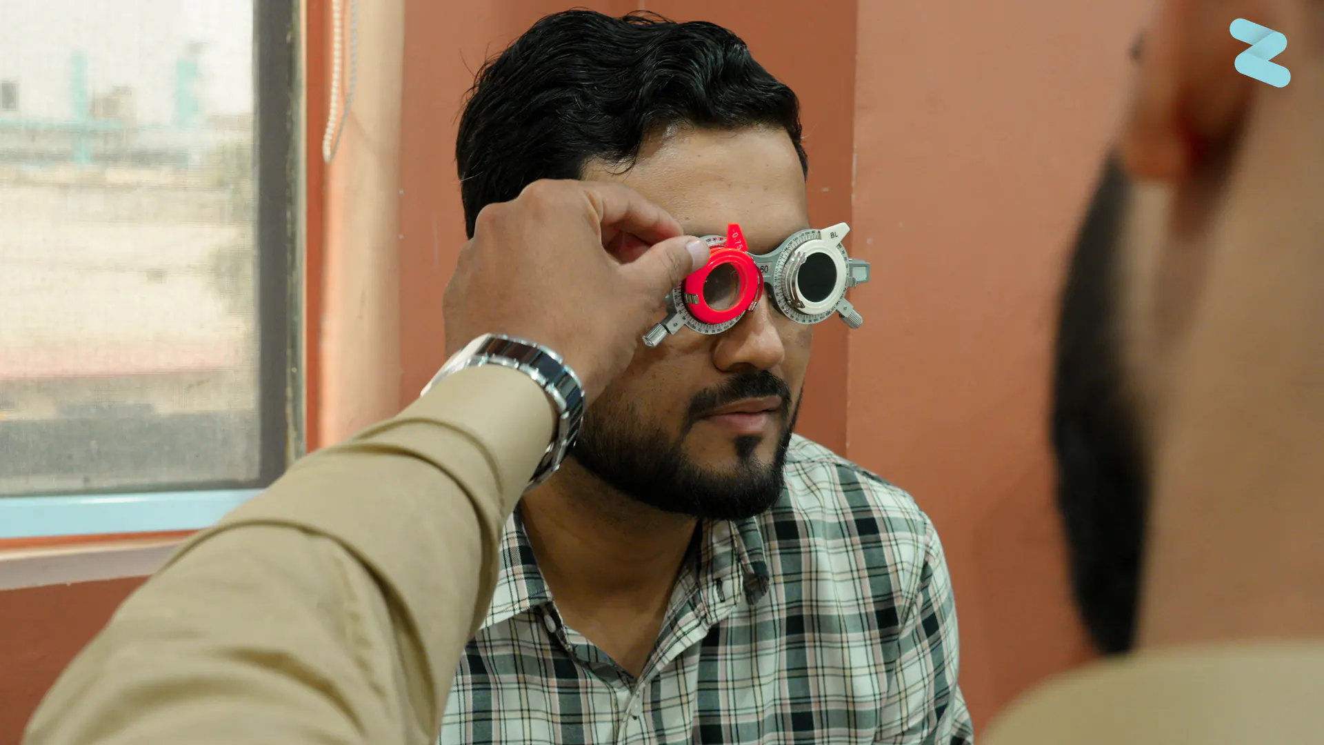 A patient wearing a trial frame during a vision test
