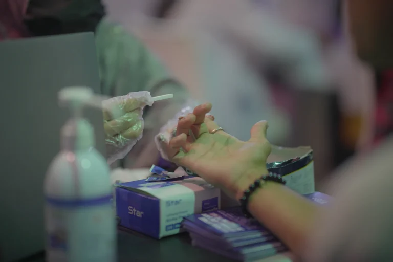 A health worker preparing a rapid blood test at a ZMT clinic