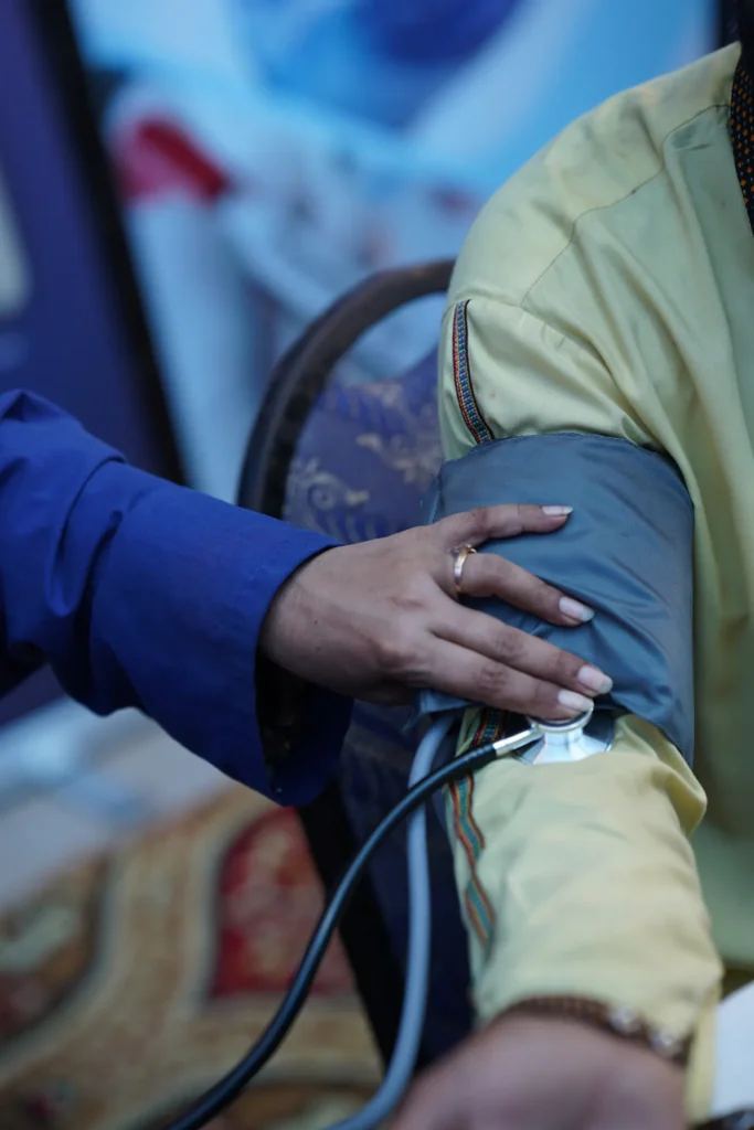 A ZMT clinician checking a patient's blood pressure