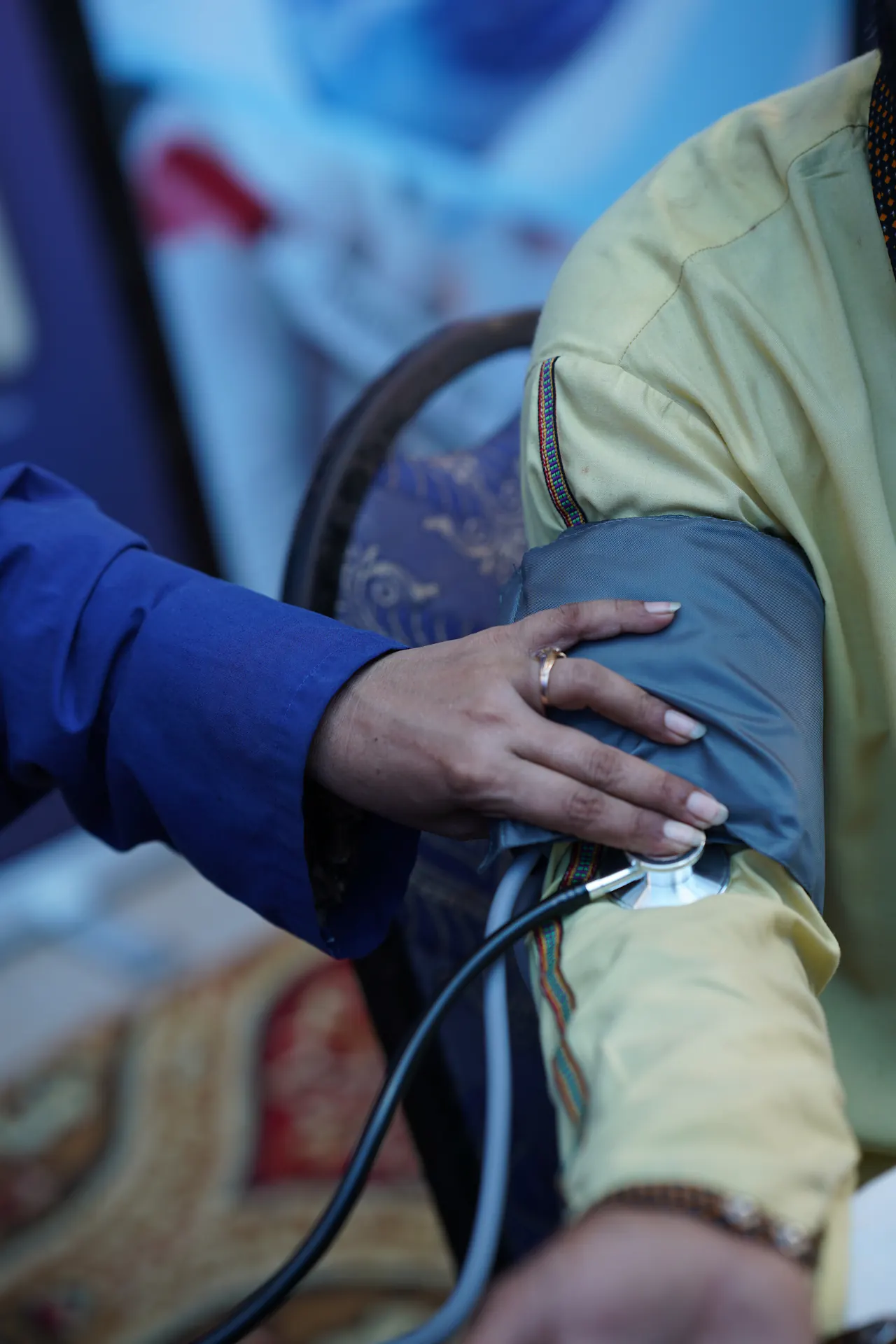 A ZMT clinician taking a patient's blood pressure