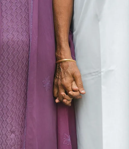 Elderly couple holding hands, the parents many people give sadaqah jariyah for