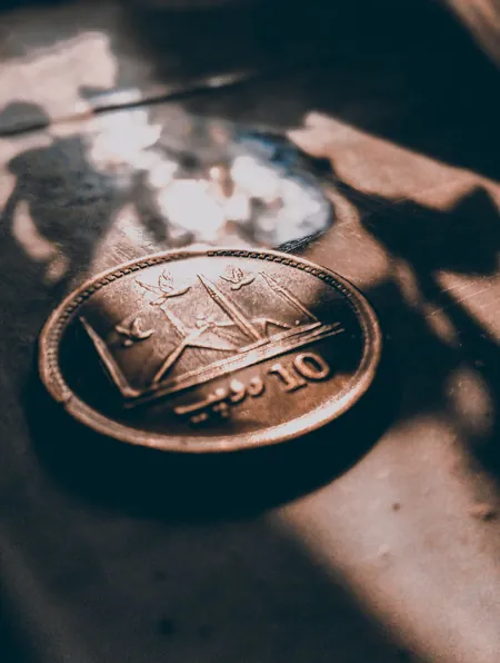 Pakistani ten rupee coin in sunlight; sadaqah has no minimum amount