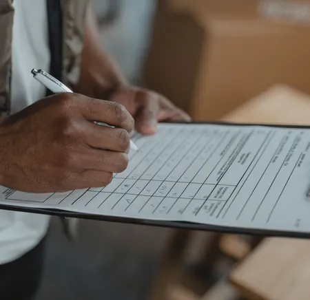 Person filling in a checklist on a clipboard, the due diligence to do before you sponsor a clinic
