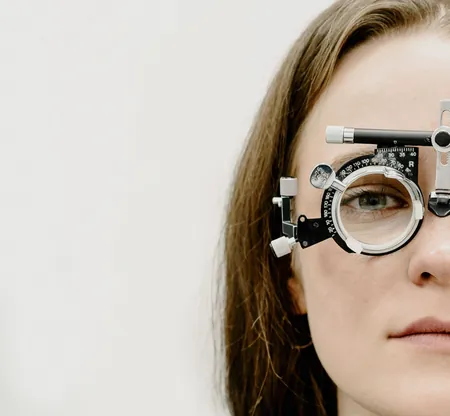 Woman wearing a trial lens frame during an eye test, like those at a mobile eye clinic