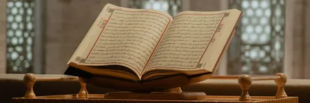 Open Quran on a wooden stand in a mosque; zakat rules decide what clinic sponsorship it can fund