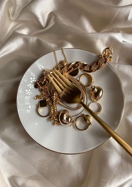 Gold jewellery on a white plate, counted towards the zakat nisab